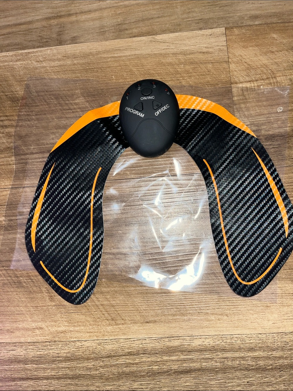Black and Orange Wireless Muscle Stimulator Pad - Fitness Toning Device